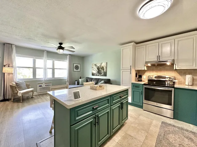 a kitchen with a sink stove and microwave