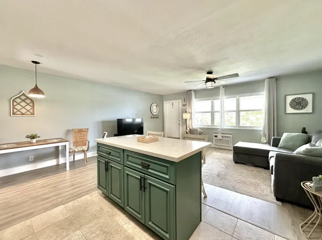 a kitchen with a stove and a living room