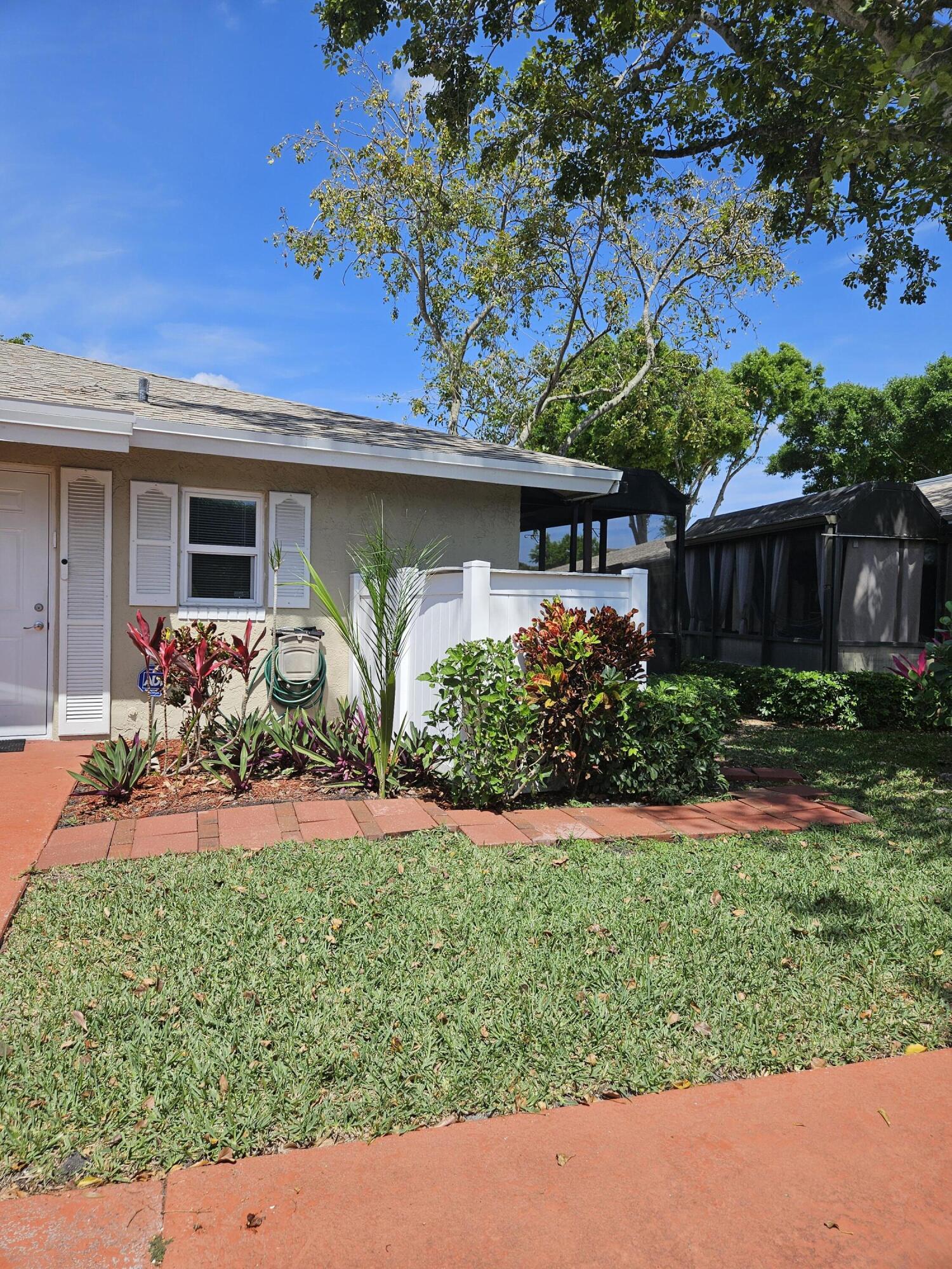 8977 Echo Lane, Unit D Boca Raton, FL 33496 - Photo 13 of 13 front view of a house with a yard