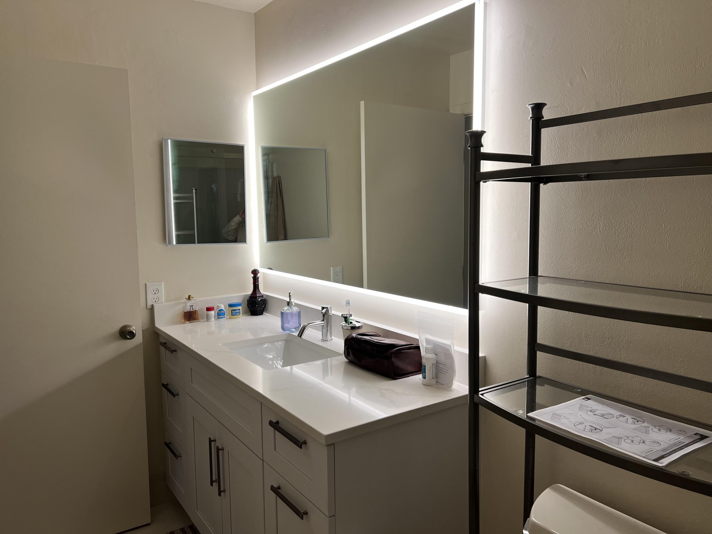 8977 Echo Lane, Unit D Boca Raton, FL 33496 - Photo 2 of 13 a bathroom with a sink and a mirror