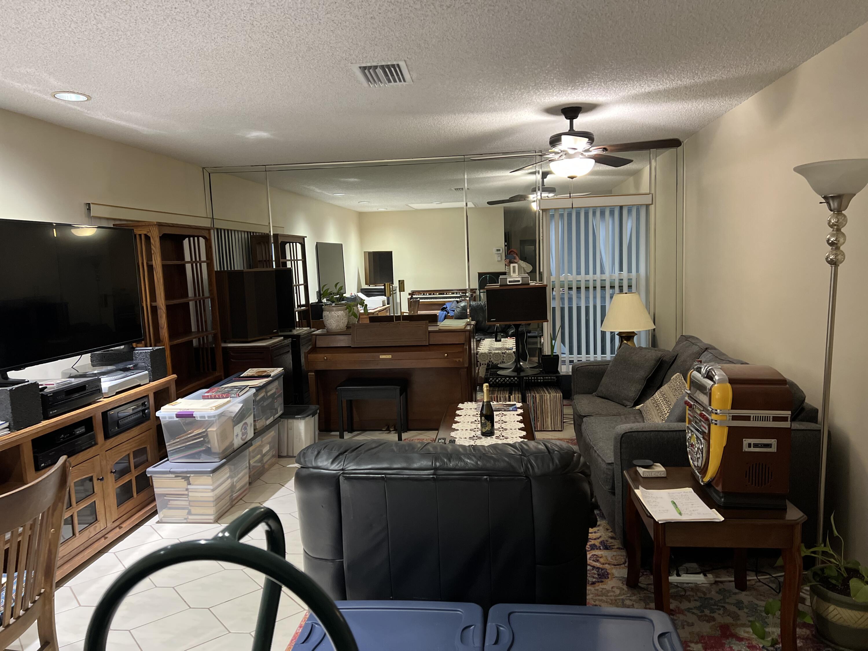 8977 Echo Lane, Unit D Boca Raton, FL 33496 - Photo 8 of 13 a living room with furniture and a flat screen tv