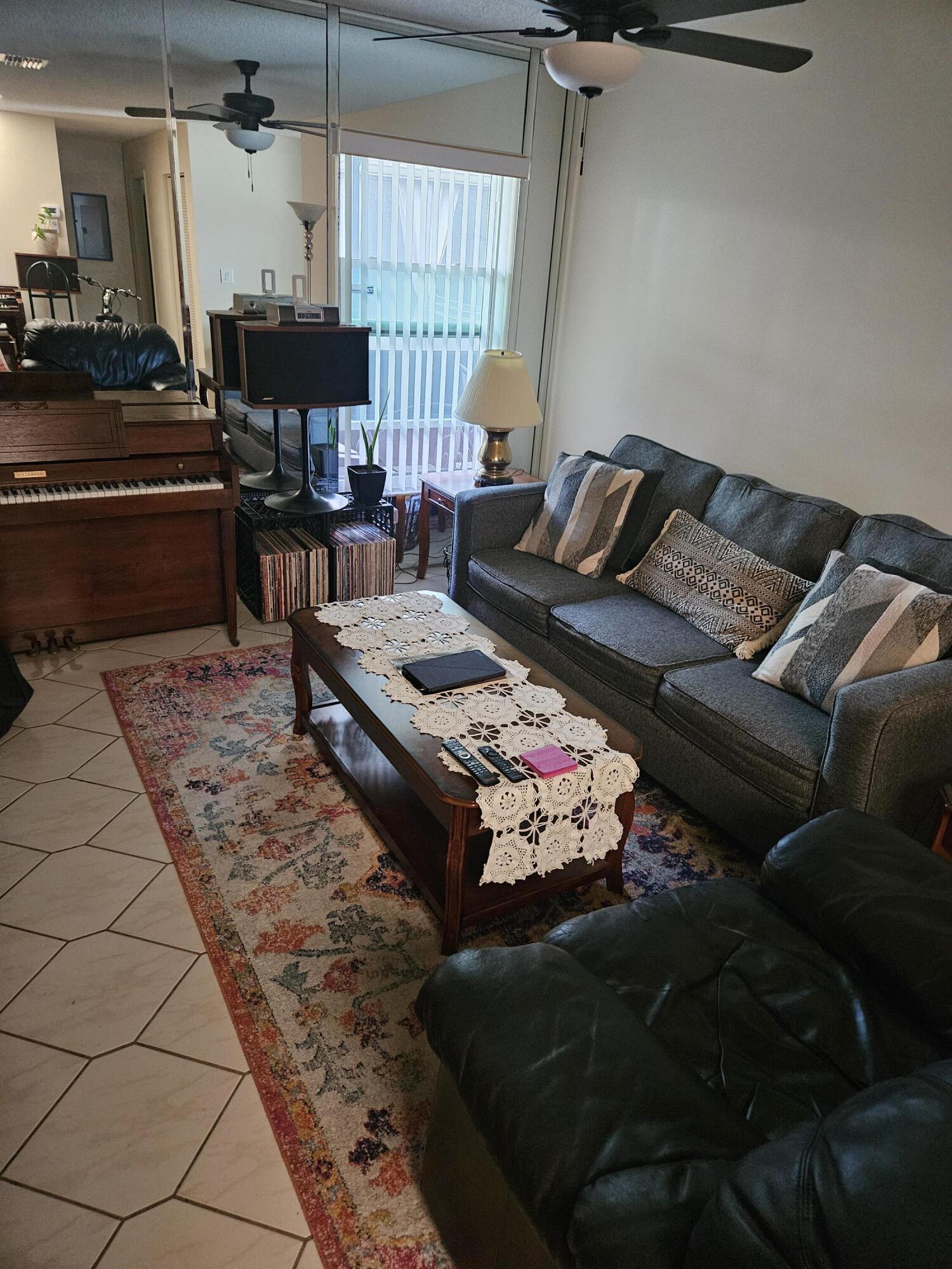8977 Echo Lane, Unit D Boca Raton, FL 33496 - Photo 9 of 13 a living room with lots of furniture and a rug