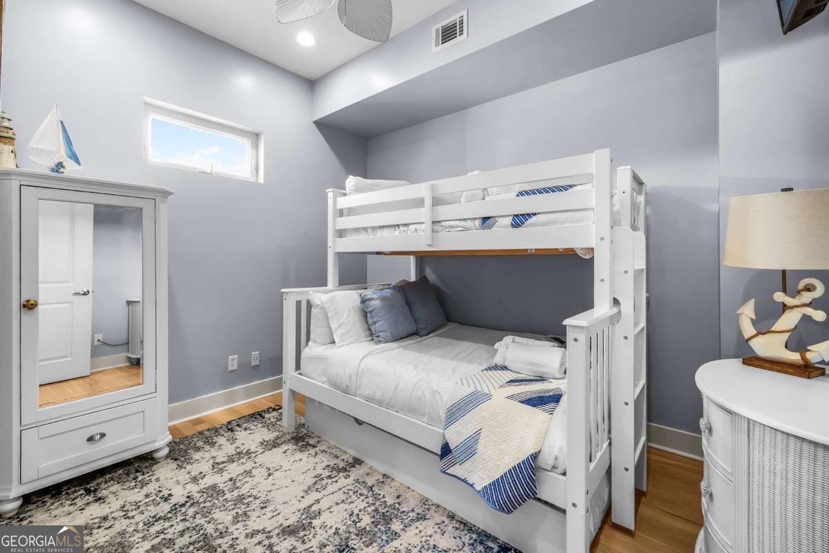 8 18th Street Tybee Island, GA 31328 - Photo 38 of 50 a bedroom with a bed and a window