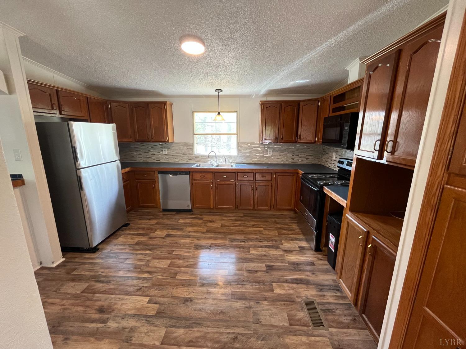 33 Pin Oak Court Evington, VA 24550 - Photo 11 of 19 a large kitchen with a stove a refrigerator and a sink