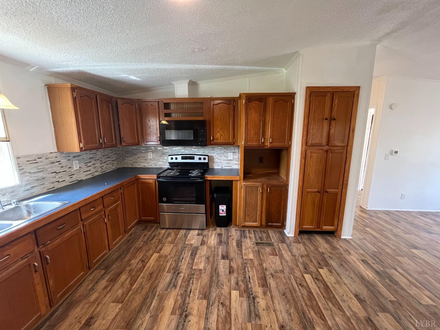 33 Pin Oak Court Evington, VA 24550 - Photo 12 of 19 a kitchen with stainless steel appliances granite countertop a refrigerator and a stove top oven