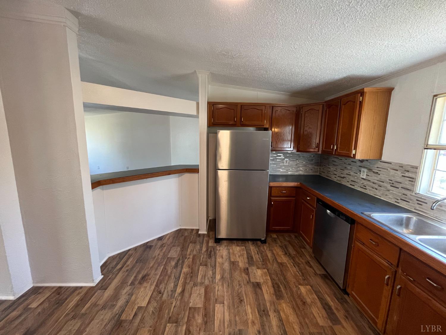 33 Pin Oak Court Evington, VA 24550 - Photo 13 of 19 a kitchen with a refrigerator and wooden floor
