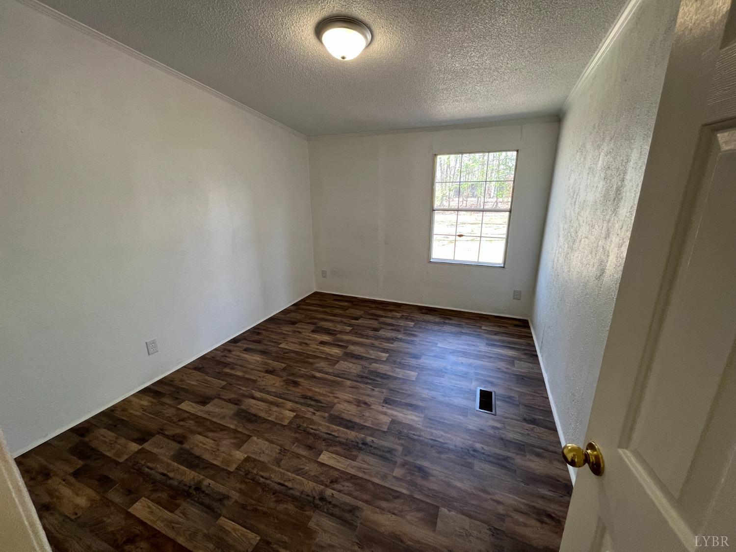 33 Pin Oak Court Evington, VA 24550 - Photo 16 of 19 wooden floor in an empty room with a window