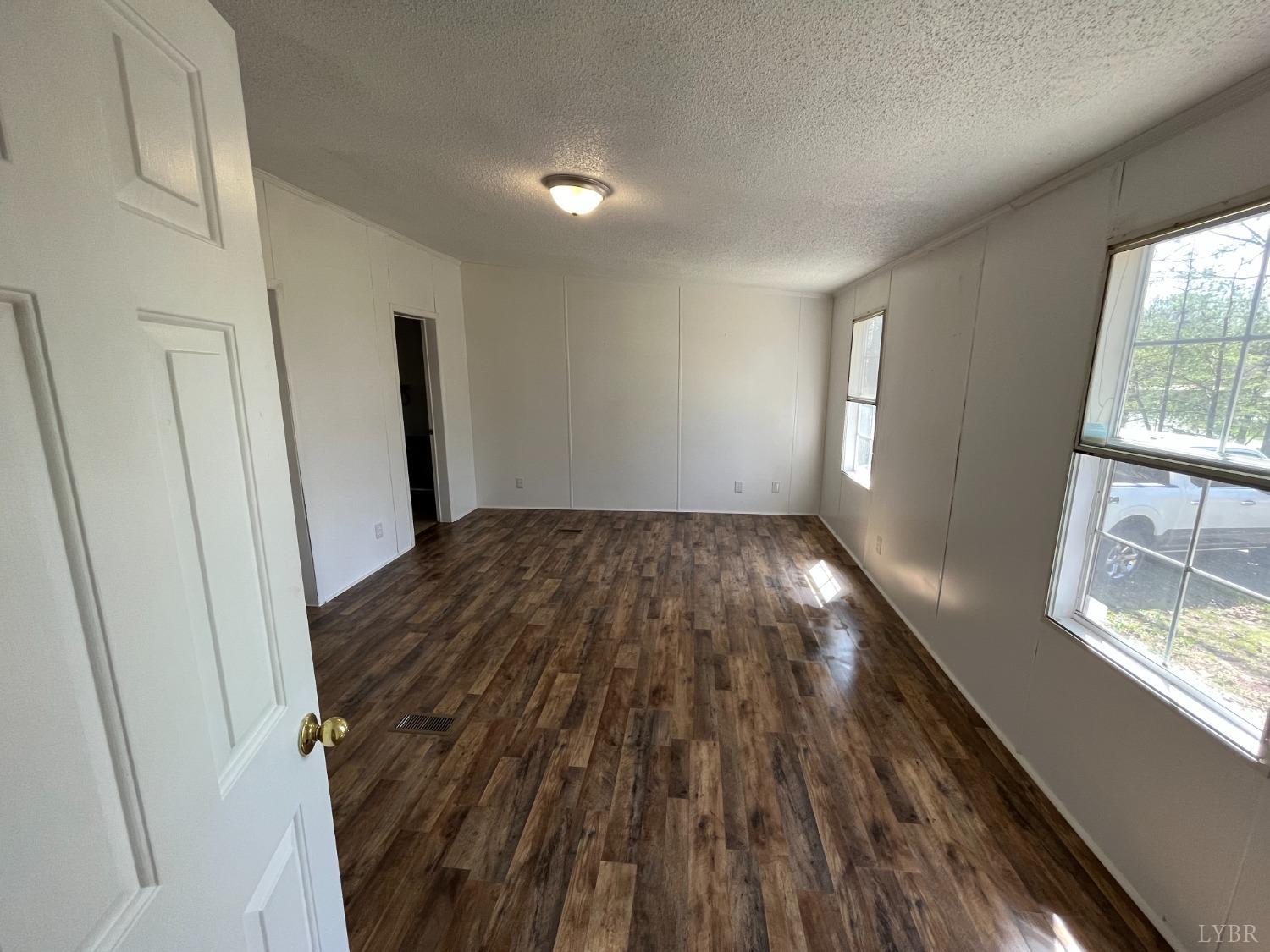 33 Pin Oak Court Evington, VA 24550 - Photo 3 of 19 wooden floor in an empty room with a window