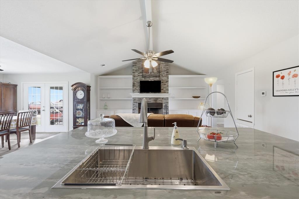 110 Highview Road Ennis, TX 75119 - Photo 14 of 40 Spacious kitchen island featuring an undermount stainless steel sink and a contemporary faucet