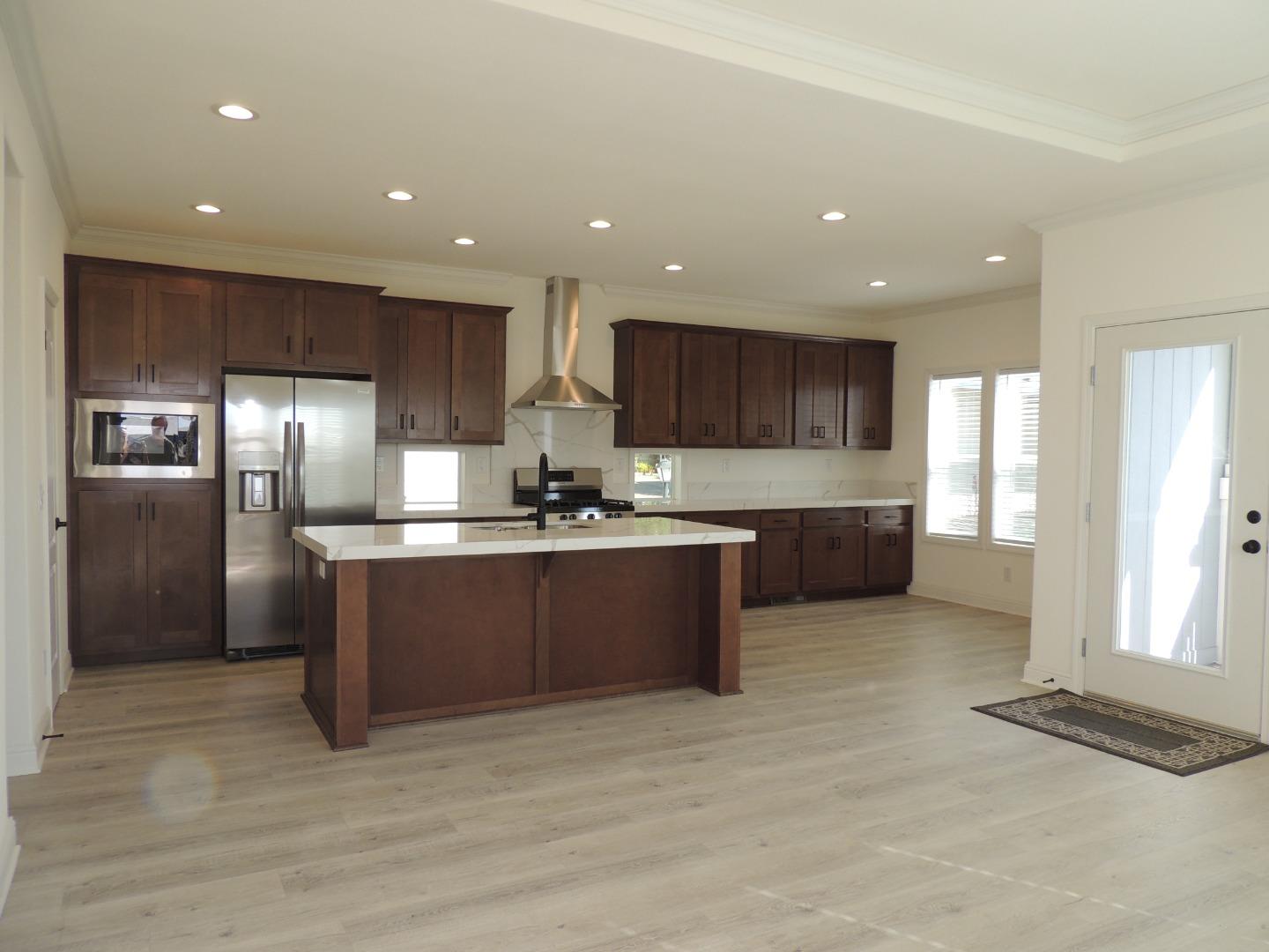 100 North Rodeo Gulch Road, Unit 108 Soquel, CA 95073 - Photo 4 of 17 a kitchen with stainless steel appliances granite countertop a refrigerator and a sink
