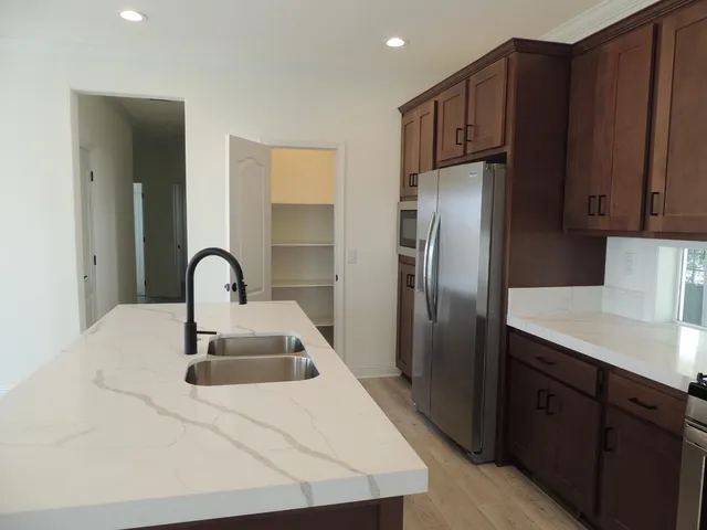 a kitchen with stainless steel appliances a refrigerator and a sink