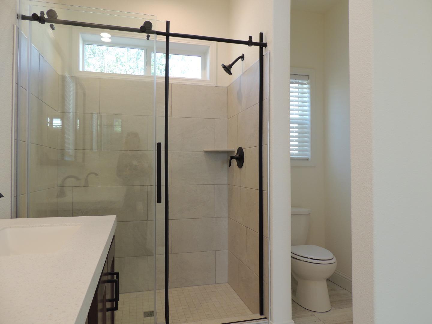 100 North Rodeo Gulch Road, Unit 108 Soquel, CA 95073 - Photo 10 of 17 a bathroom with a granite countertop shower a toilet and a sink