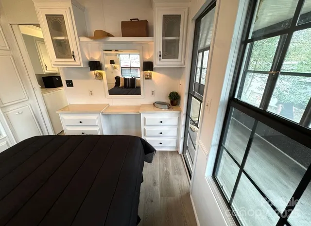 a kitchen with a sink and wooden floor