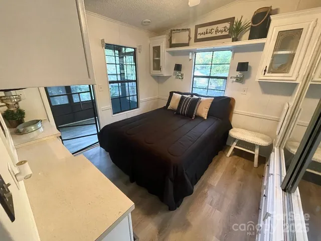 a bed sitting in a bedroom next to a window