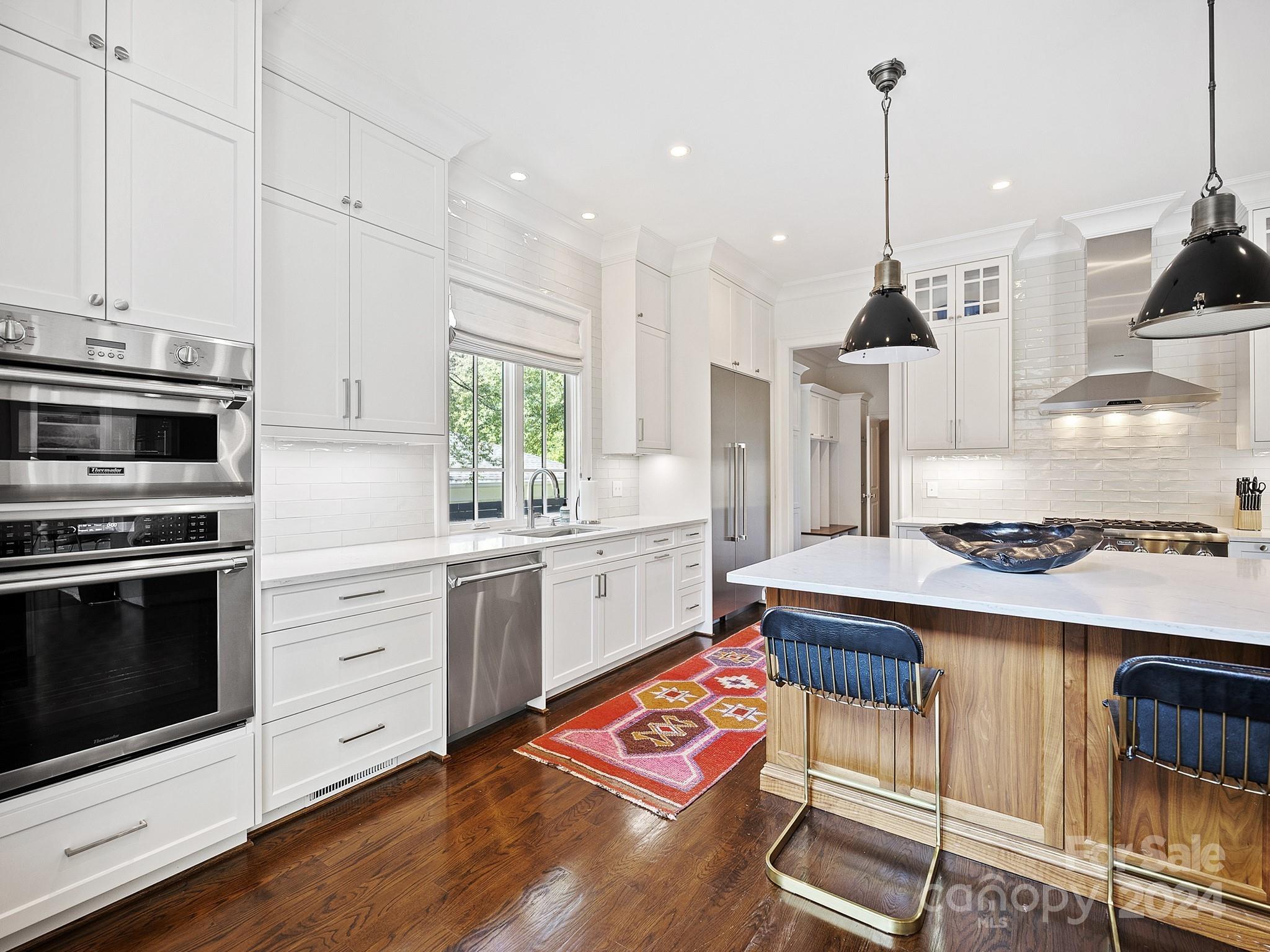 1621 Sterling Road Charlotte, NC 28209 - Photo 13 of 48 a kitchen with stainless steel appliances granite countertop a stove a sink and a wooden floors