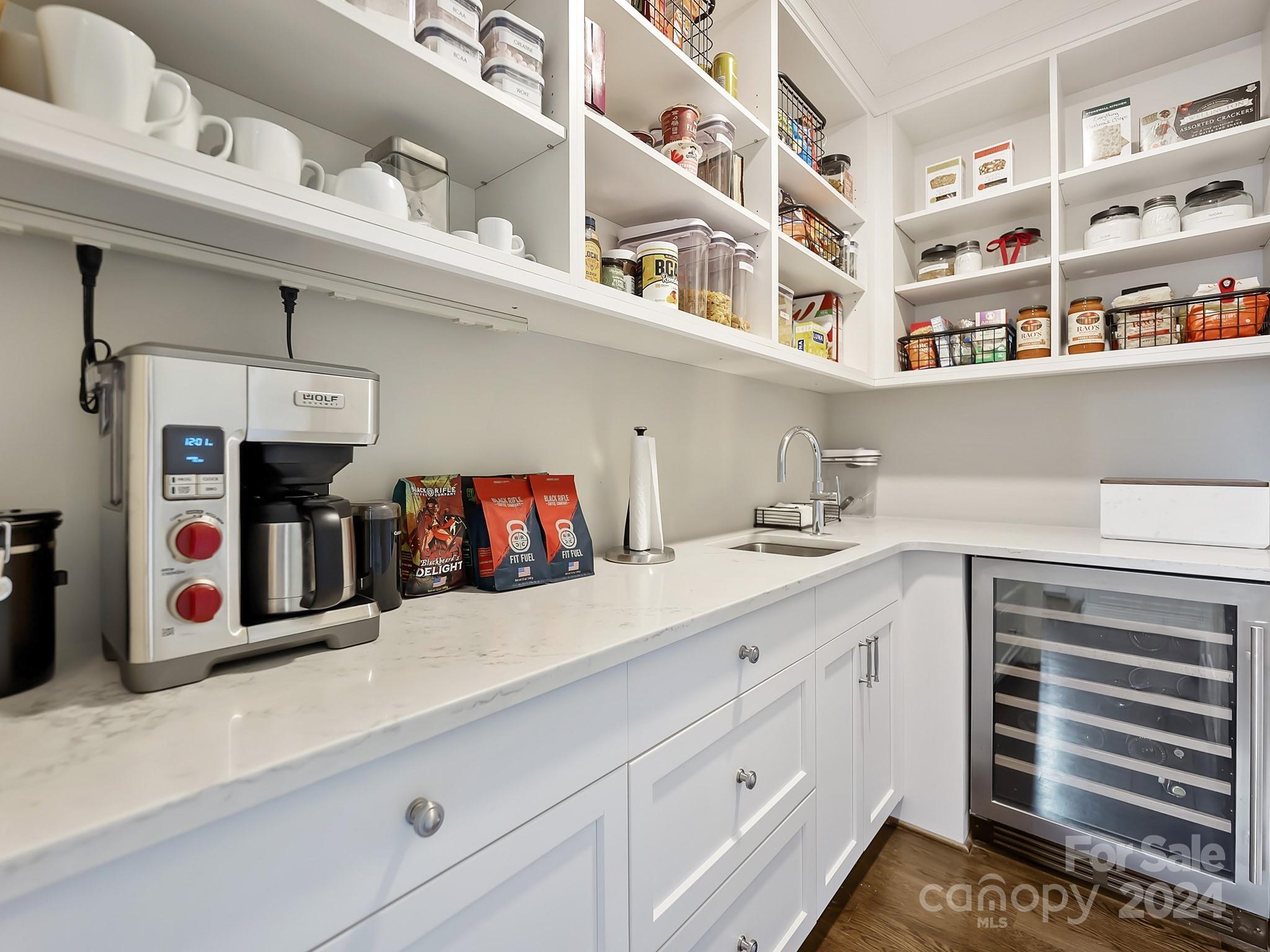 1621 Sterling Road Charlotte, NC 28209 - Photo 14 of 48 a kitchen with cabinets and white appliances