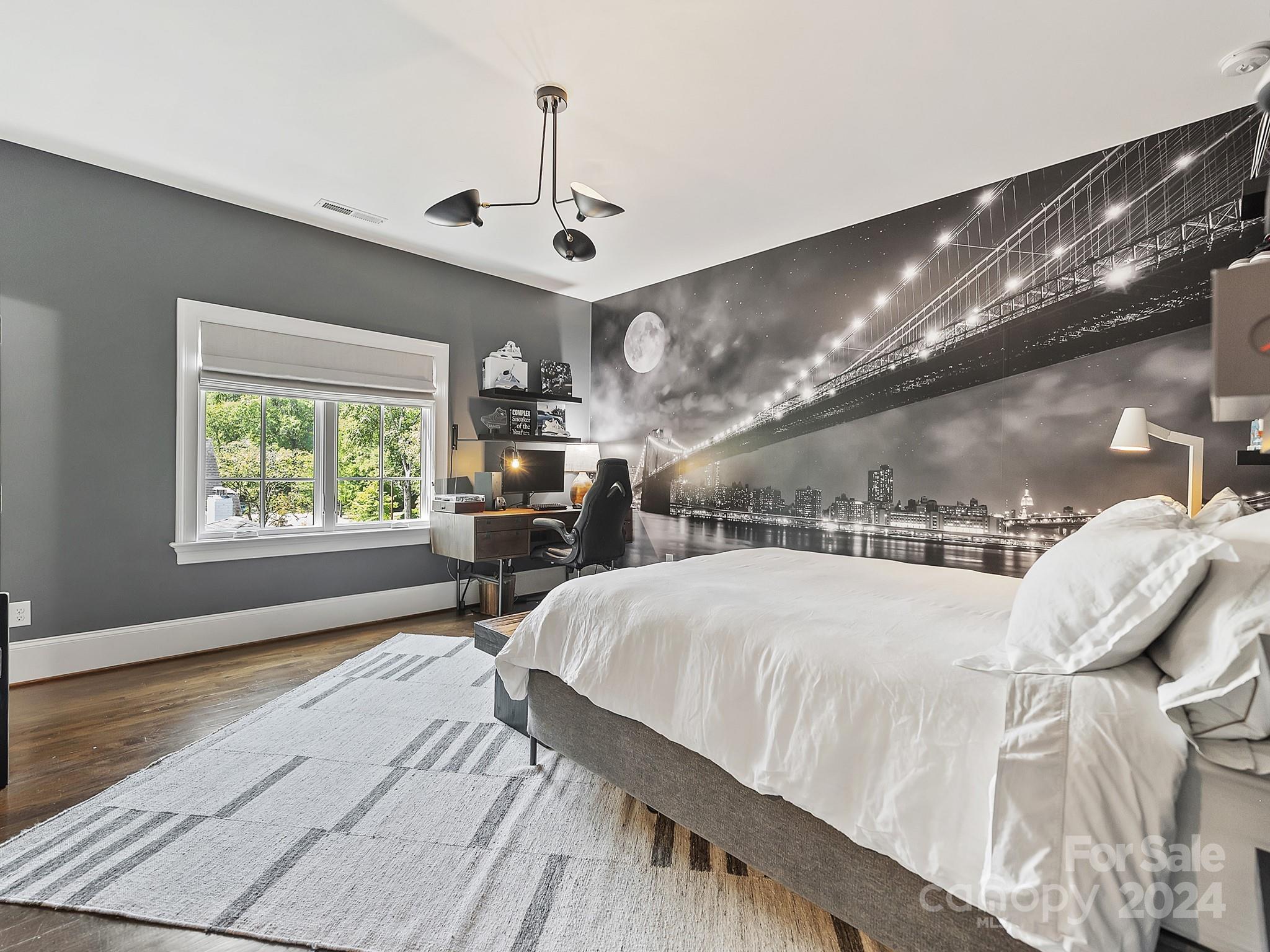 1621 Sterling Road Charlotte, NC 28209 - Photo 31 of 48 a large bedroom with a bed and a chandelier