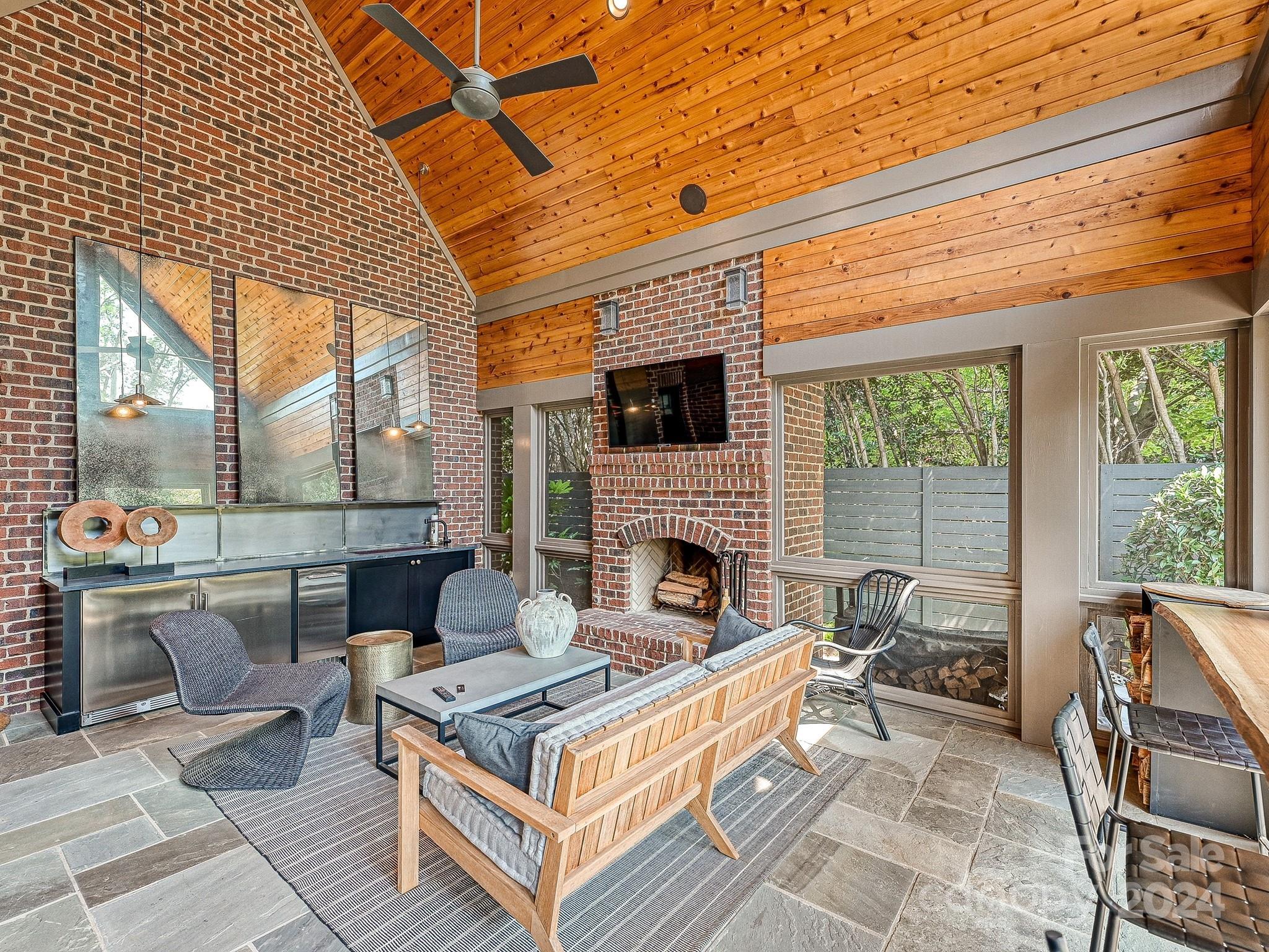 1621 Sterling Road Charlotte, NC 28209 - Photo 42 of 48 a living room with a fireplace a large window and furniture