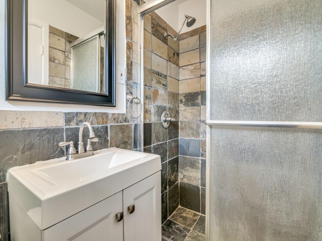 2315 Inadale Avenue Dallas, TX 75228 - Photo 24 of 36 a bathroom with a sink a toilet and a mirror