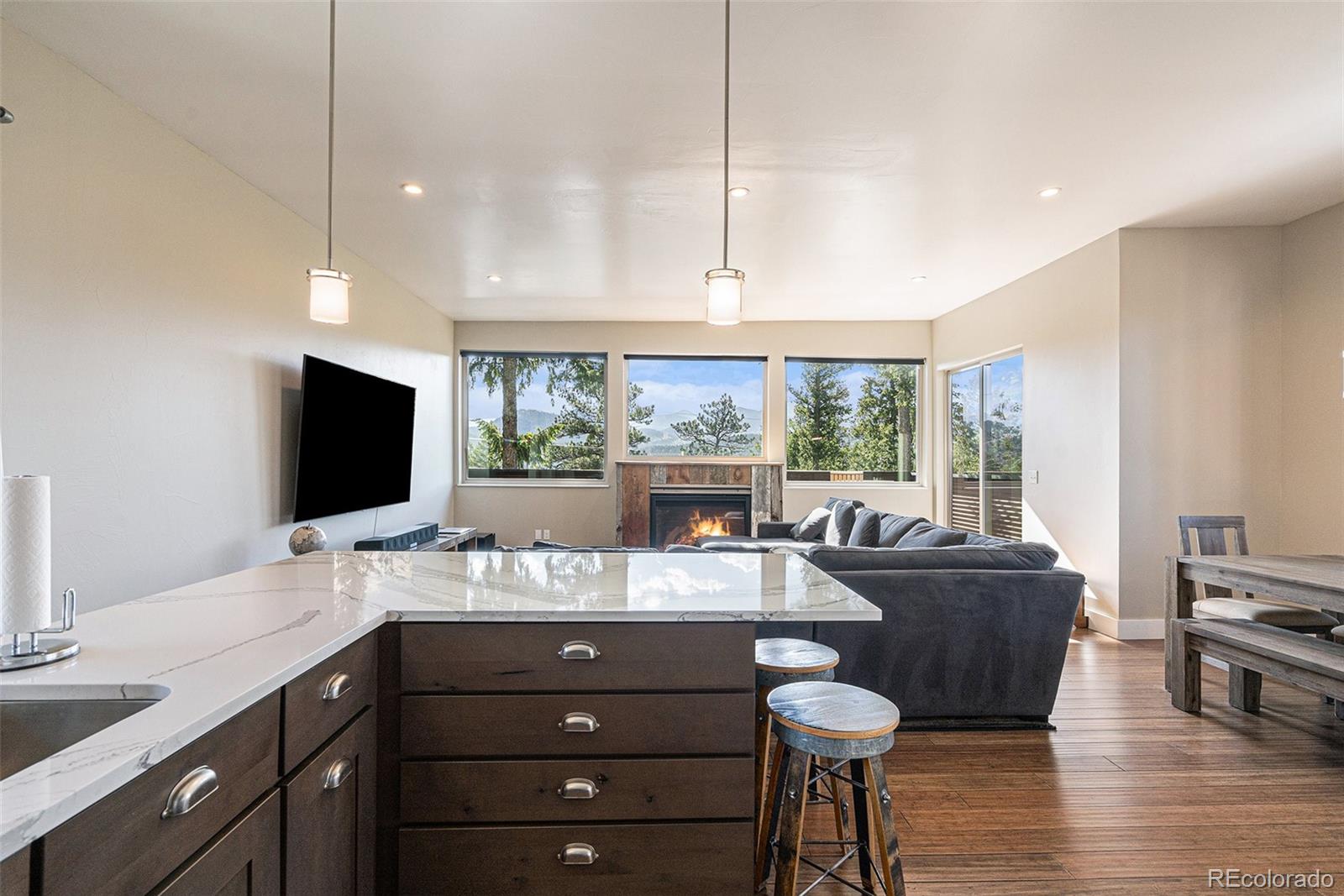 4650 Forest Hill Road Evergreen, CO 80439 - Photo 13 of 36 a room with a chandelier furniture and a large window