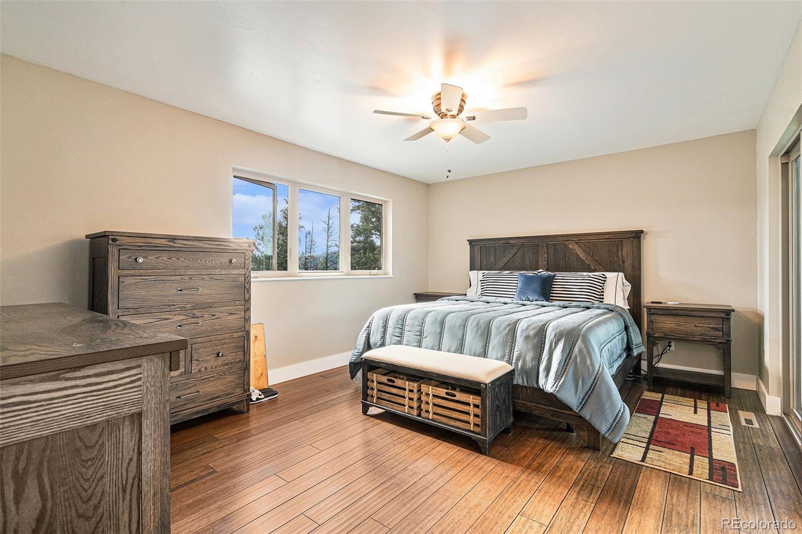 4650 Forest Hill Road Evergreen, CO 80439 - Photo 18 of 36 a bedroom with a bed and a couch