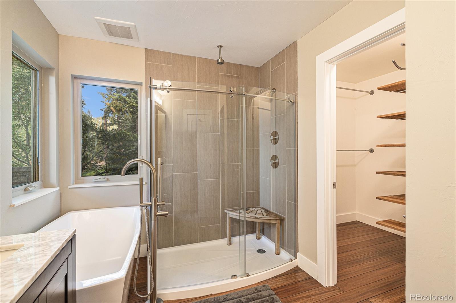 4650 Forest Hill Road Evergreen, CO 80439 - Photo 21 of 36 a bathroom with a tub shower and sink