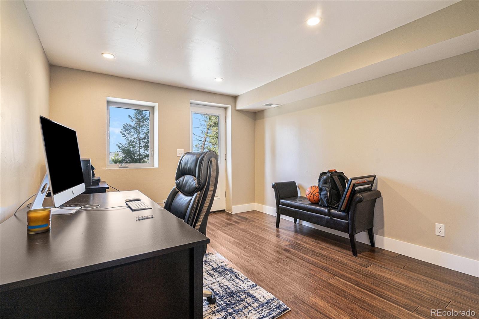 4650 Forest Hill Road Evergreen, CO 80439 - Photo 25 of 36 a view of a workspace with furniture and wooden floor
