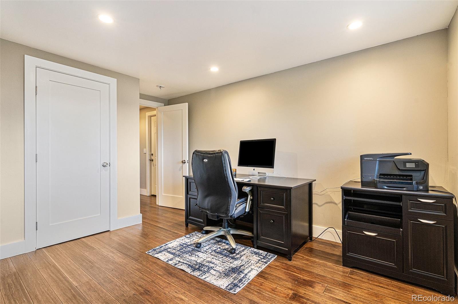 4650 Forest Hill Road Evergreen, CO 80439 - Photo 26 of 36 a view of a workspace with furniture and wooden floor
