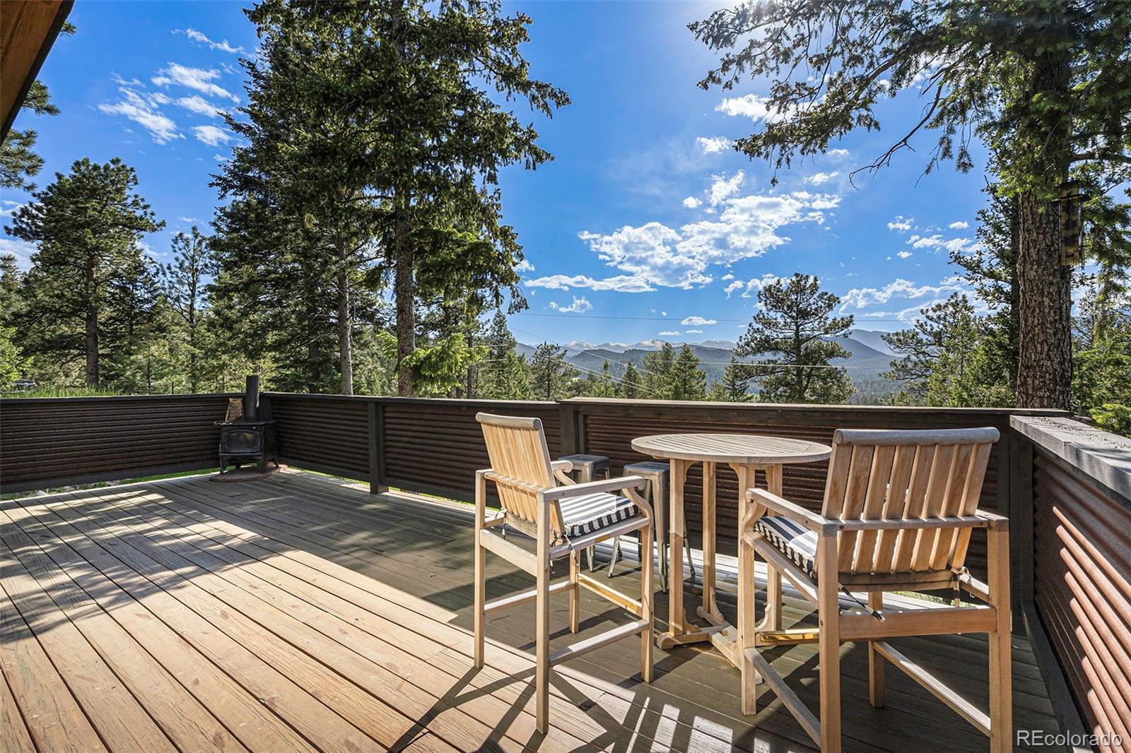 4650 Forest Hill Road Evergreen, CO 80439 - Photo 27 of 36 a view of a chairs and table on the roof deck