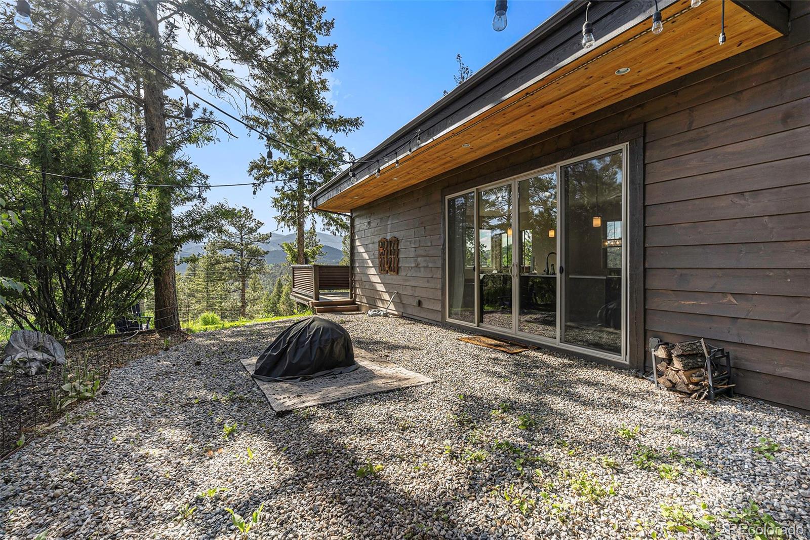 4650 Forest Hill Road Evergreen, CO 80439 - Photo 30 of 36 a backyard of a house with seating space