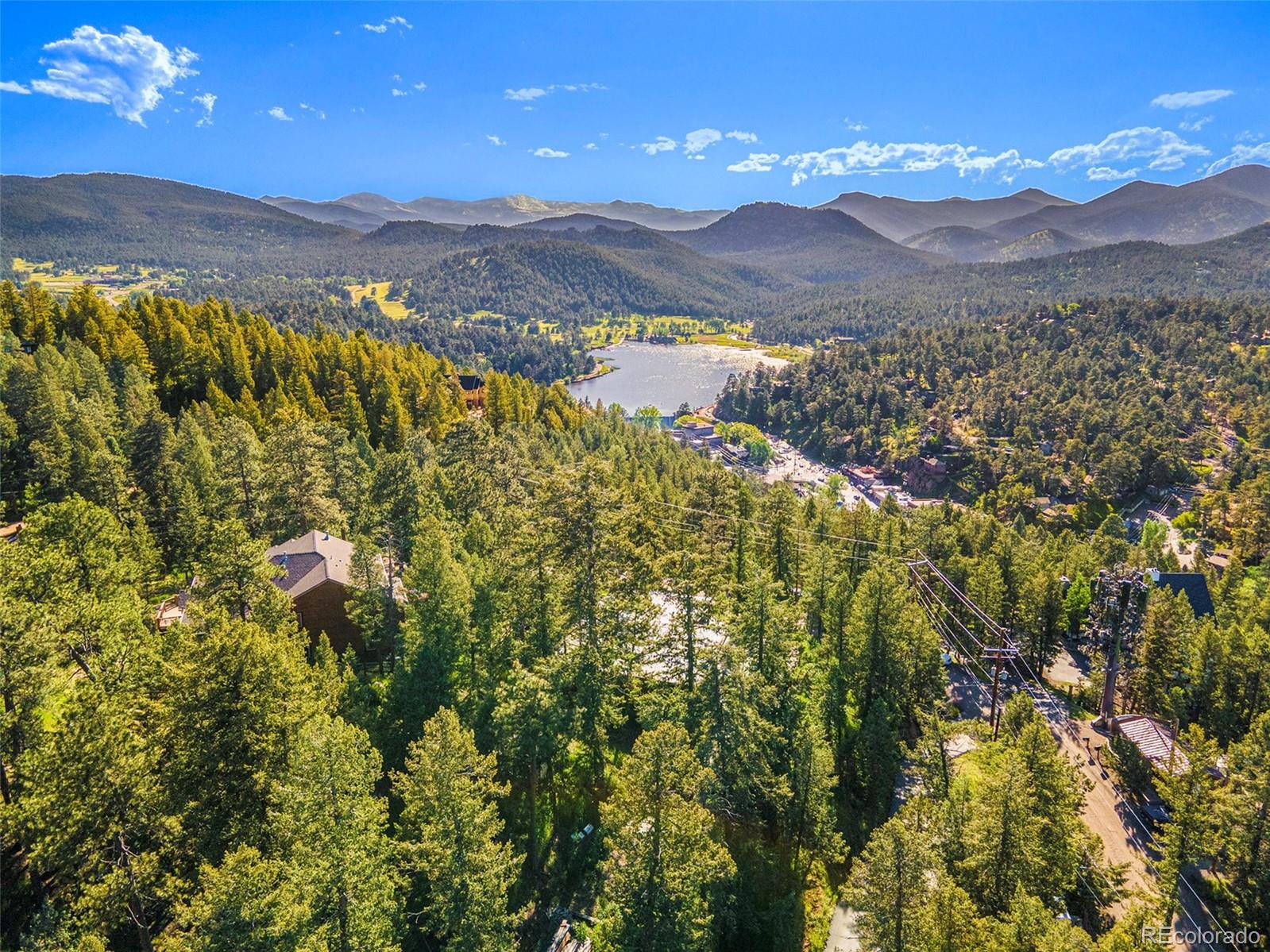 4650 Forest Hill Road Evergreen, CO 80439 - Photo 35 of 36 a view of a city with mountains in the background