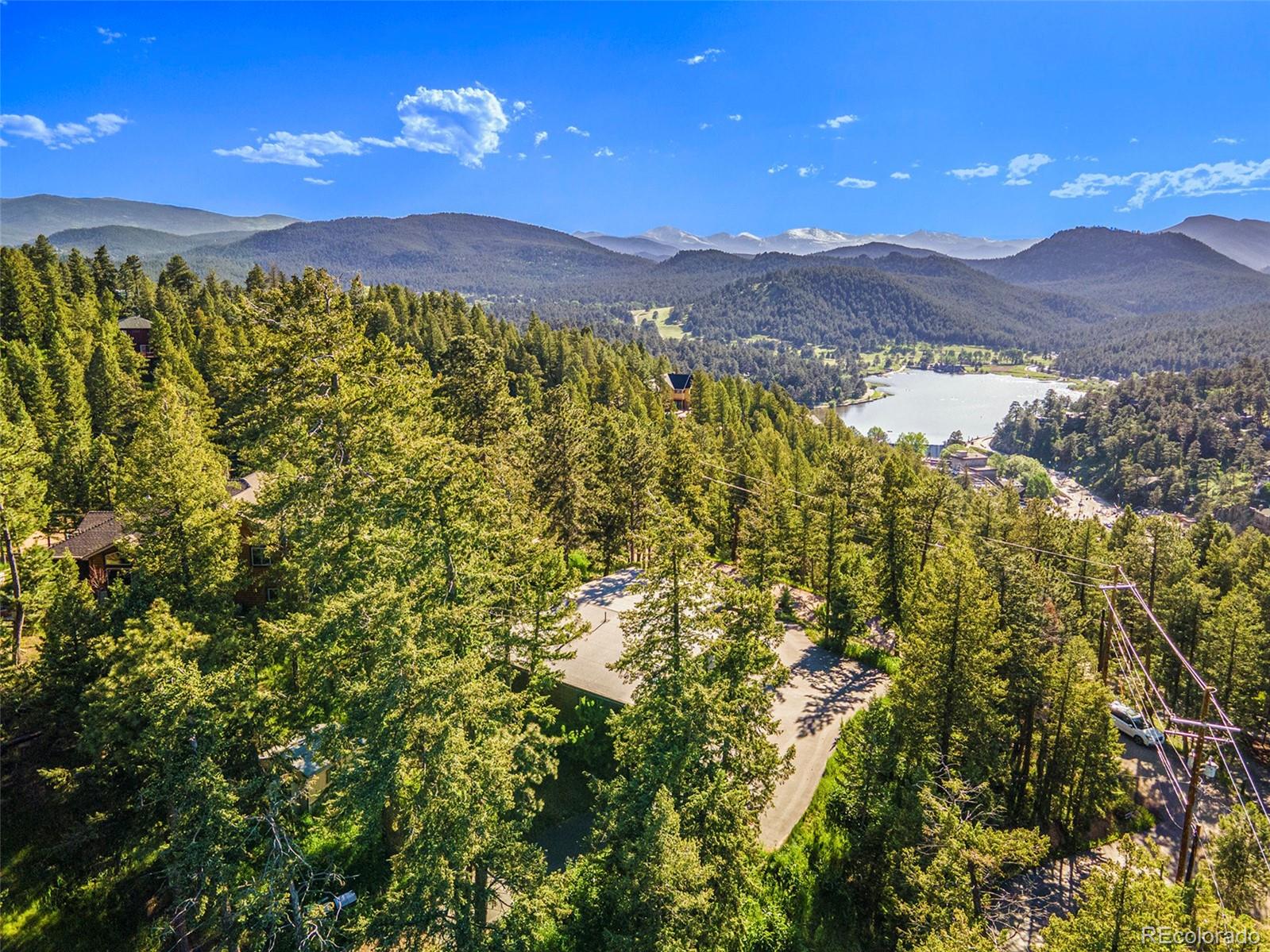 4650 Forest Hill Road Evergreen, CO 80439 - Photo 36 of 36 a view of a city with mountains in the background