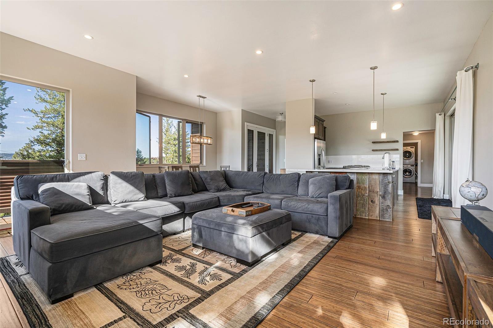 4650 Forest Hill Road Evergreen, CO 80439 - Photo 6 of 36 a living room with furniture and a fireplace