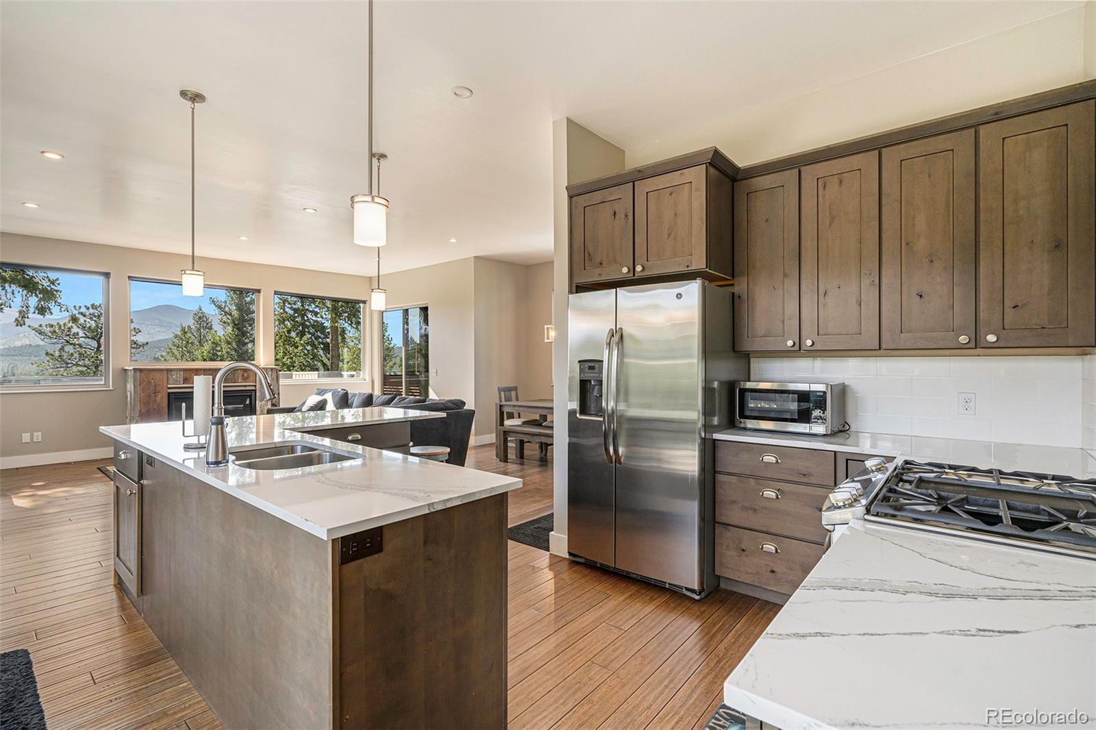 4650 Forest Hill Road Evergreen, CO 80439 - Photo 10 of 36 a kitchen with a sink stove and refrigerator