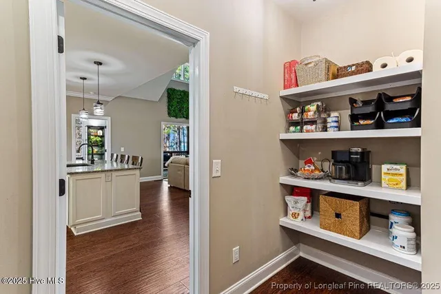 a view of a kitchen with staircase and electronic appliances