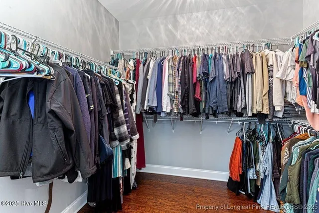 a view of a livingroom with a window and wooden floor