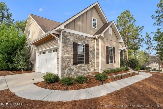 an aerial view of a house with a yard and garden