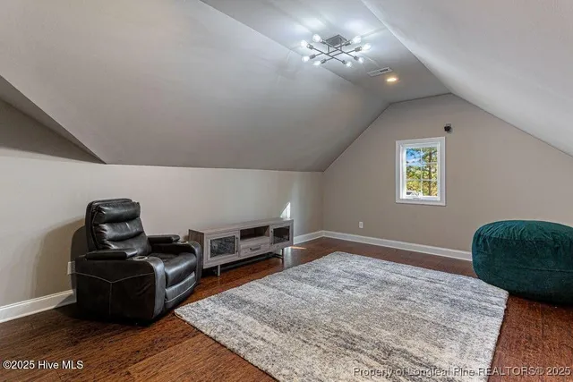 a bathroom with a granite countertop sink and a toilet