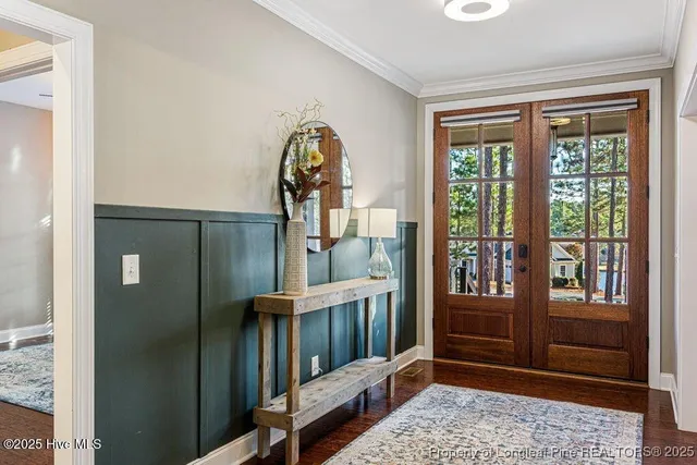 a view of a hallway with wooden floor and windows