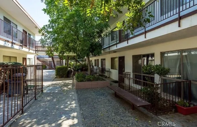 a view of a house with backyard and sitting area