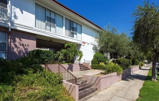 a view of a house with a small yard and plants