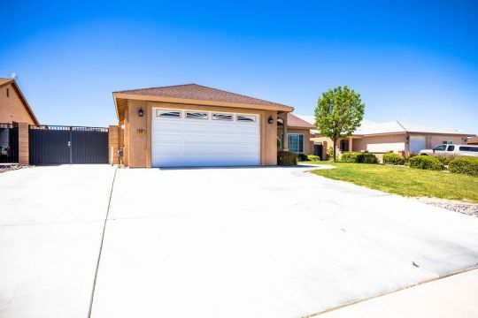 409 Acacia Street Ridgecrest, CA 93555 - Photo 5 of 34 a front view of a house with a yard