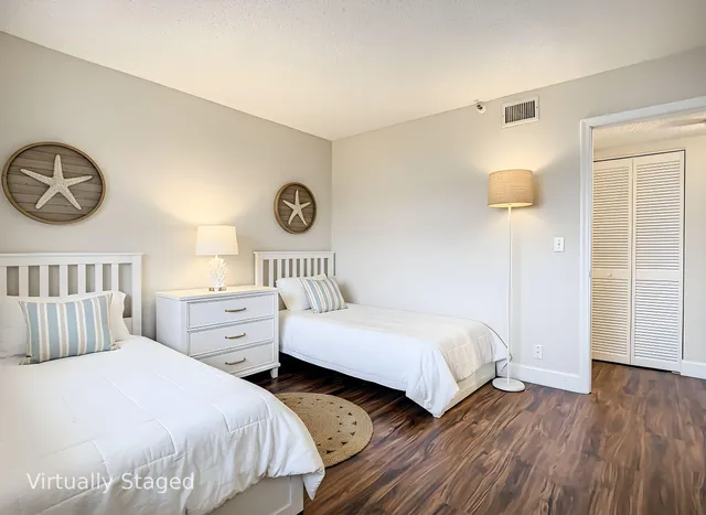 a bedroom with two beds and a table