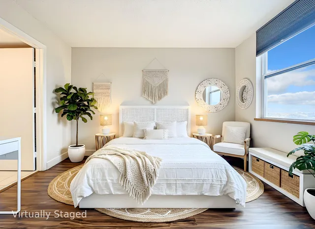 a bedroom with a bed and a potted plant