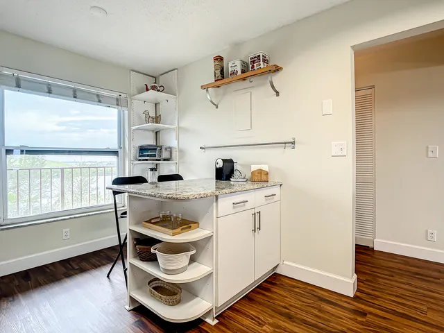 a kitchen with a sink cabinets and wooden floor