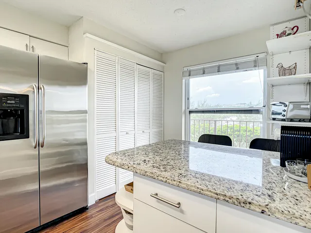 a kitchen with refrigerator and window
