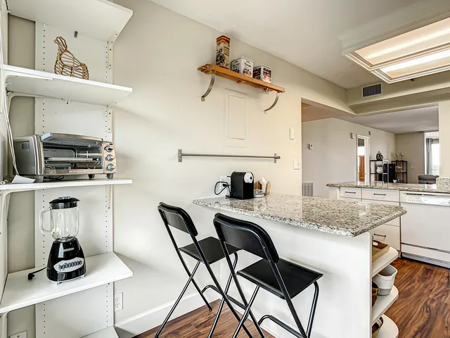 a kitchen with a sink a stove and chairs