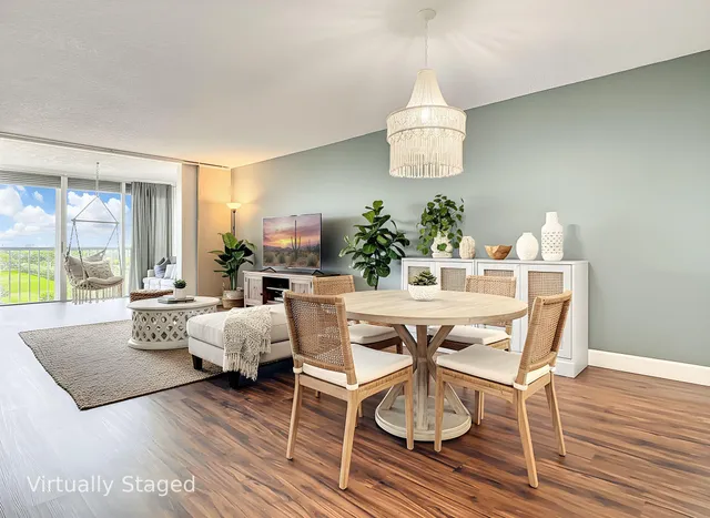 a view of a dining room with furniture wooden floor and a chandelier