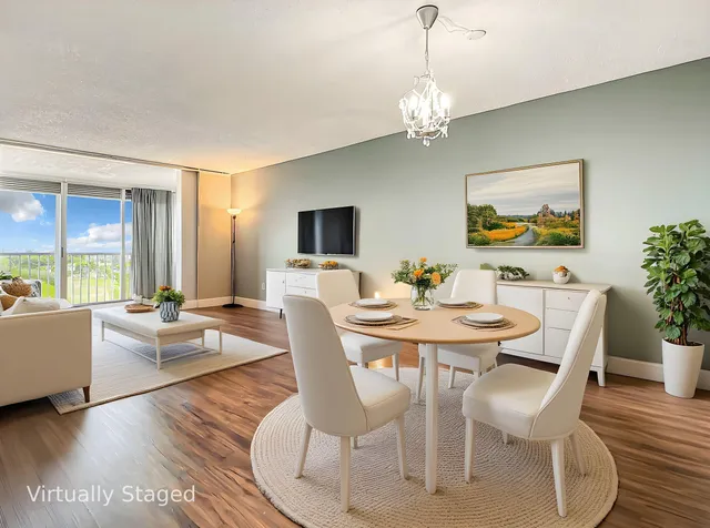 a view of a dining room with furniture window and wooden floor