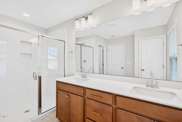 a bathroom with a sink double vanity and a mirror